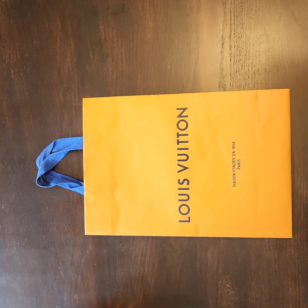Louis Vuitton gift bag. It's 14X10X4. Has very small tear in the lower fold
